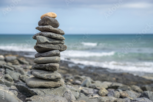 Close-up of stack of stones in perfect balance on a tranquil sunny beach in Fuerteventura, SpainClose-up of stack of stones in perfect balance on a tranquil sunny beach in Fuerteventura, Spain