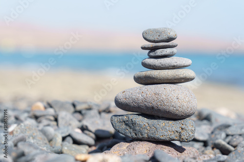 Close-up of stack of stones in perfect balance on a tranquil sunny beach in Fuerteventura, SpainClose-up of stack of stones in perfect balance on a tranquil sunny beach in Fuerteventura, Spain