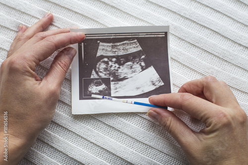 Pregnancy test and ultrasound photo