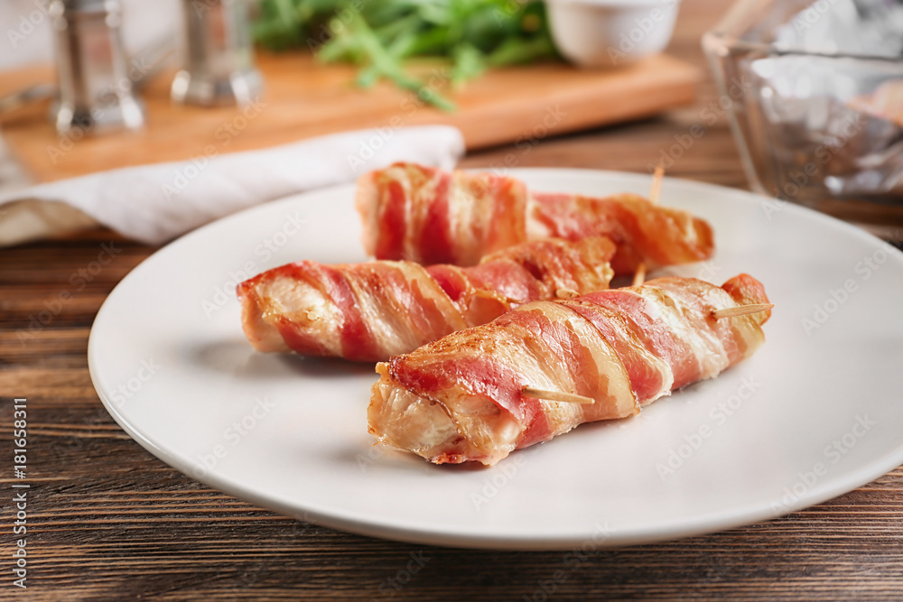 Plate with bacon wrapped chicken nuggets on table Plate with bacon wrapped chicken nuggets on table