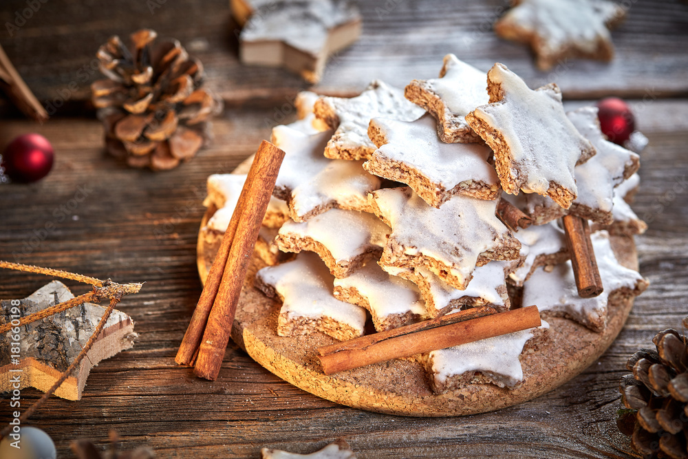 Cinnamon star cookies for christams with pine coins and little red christmas balls Cinnamon star cookies for christams with pine coins and little red christmas balls