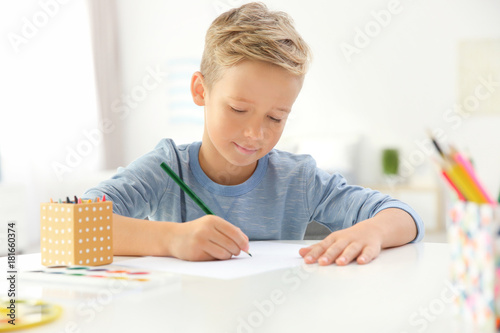 Cute little boy drawing at ...