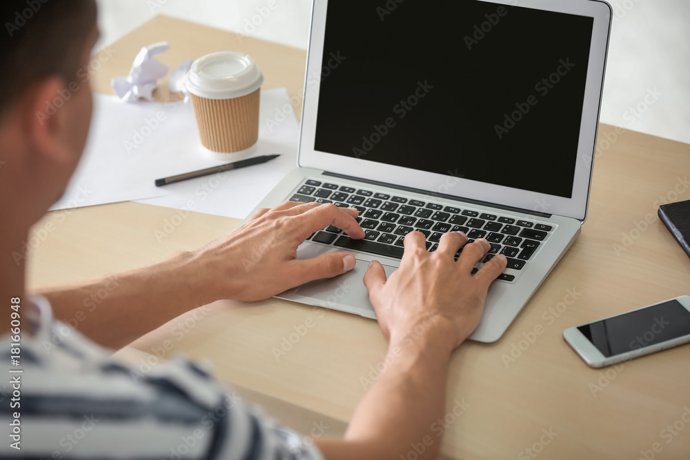 Man using laptop indoors Man using laptop indoors