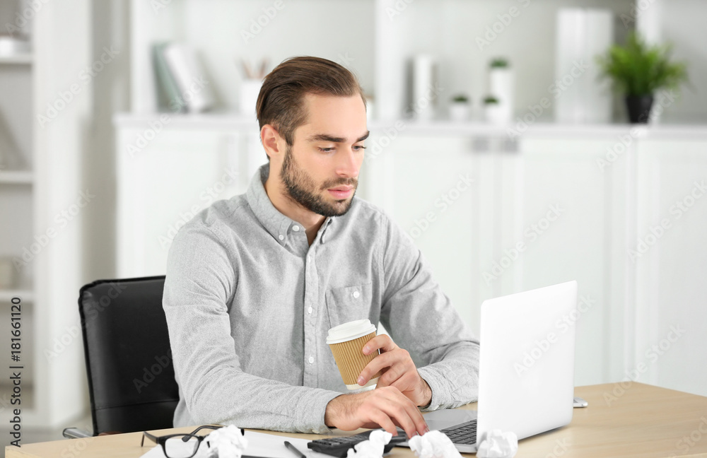 Attractive man with laptop in office