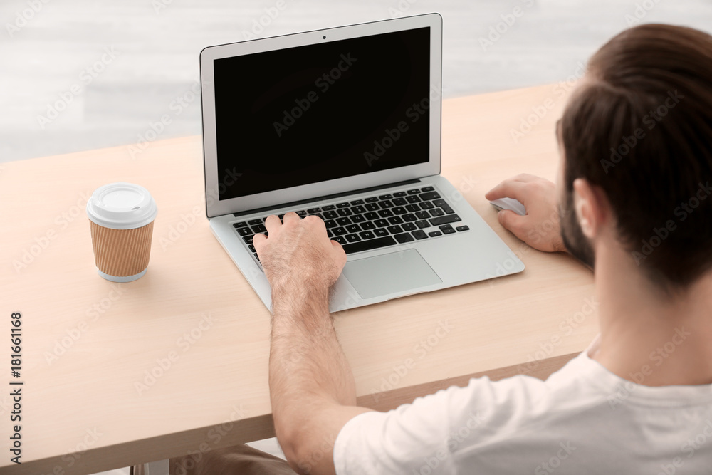Man using laptop indoors Man using laptop indoors