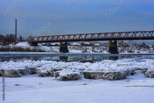 ice floes and a bridge across the river © photollurg