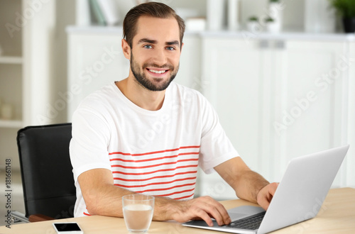 Attractive man with laptop ...