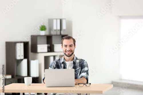 Attractive man with laptop ...