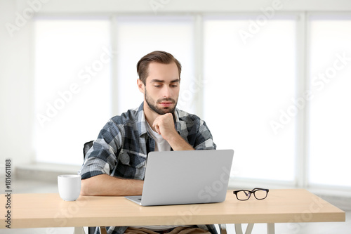 Attractive man with laptop ...