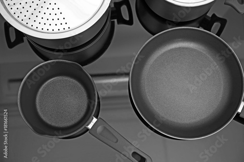 Frying pan and saucepan on electric stove in kitchen