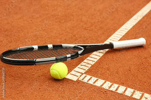 Tennis racket and ball on court © Africa Studio