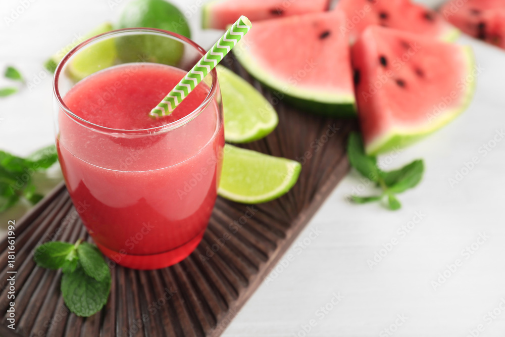 Glass with fresh watermelon smoothie on table Glass with fresh watermelon smoothie on table