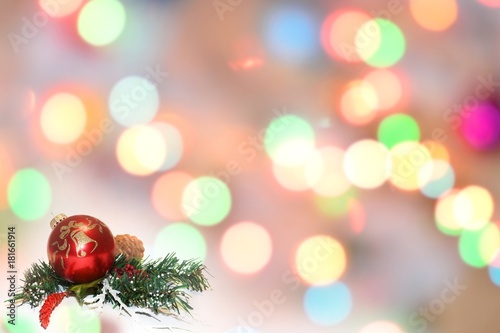 Christmas balls and fir branches with decorations on abstract background  blurred  sparking  glowing. Happy New Year and Xmas theme
