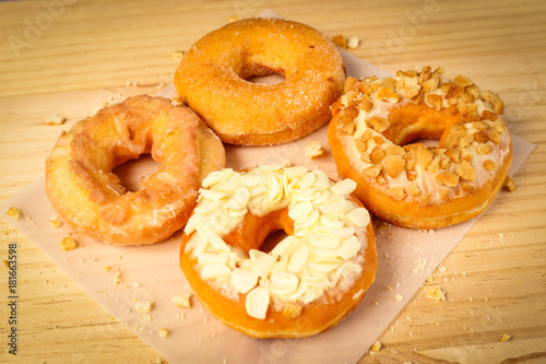 Donuts on wooden background © thechatat