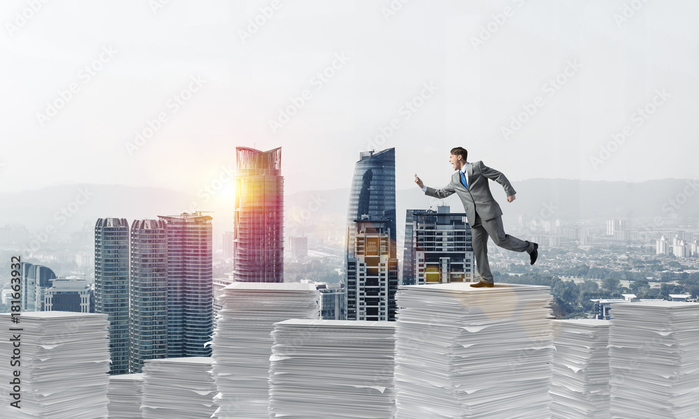 Fototapeta premium Precise businessman in suit running with phone.