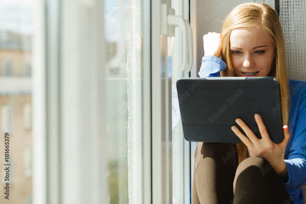 Sad teen woman using tablet Sad teen woman using tablet