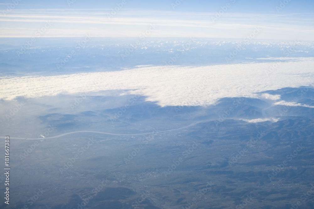 Fototapeta premium Over the clouds. Photo from plane.