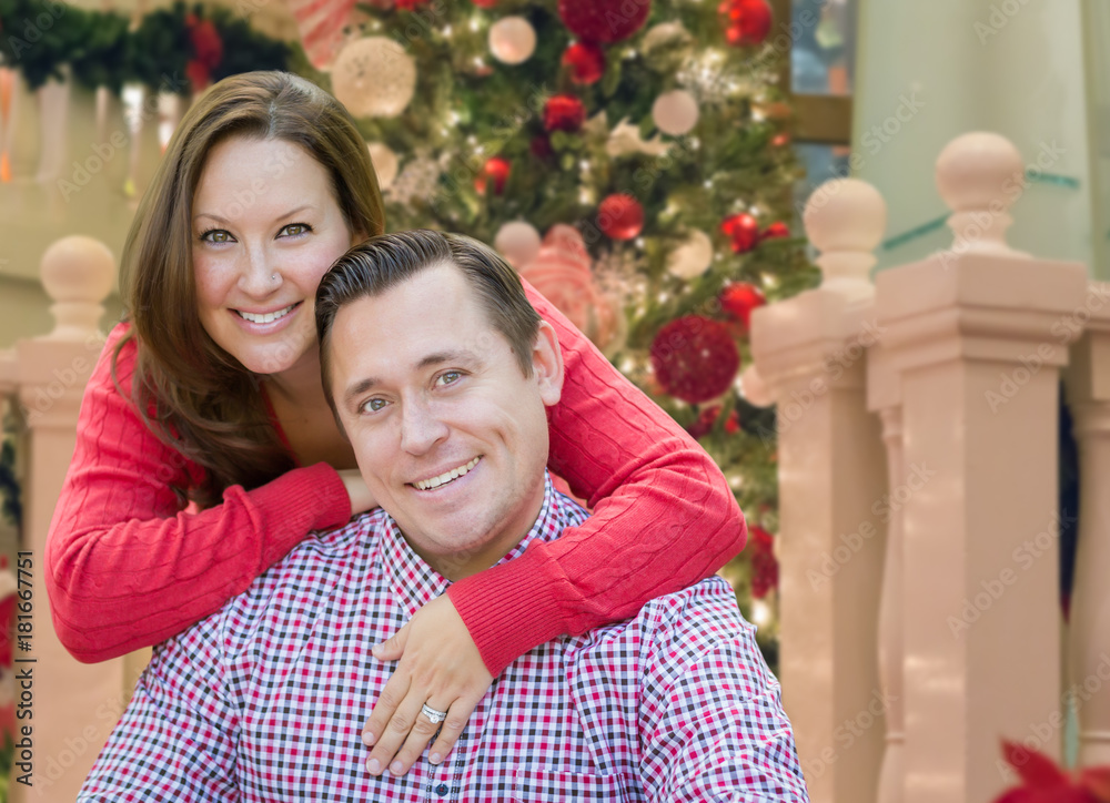 Caucasian Couple Hugging In Front of Decorated Christmas Tree. Caucasian Couple Hugging In Front of Decorated Christmas Tree.