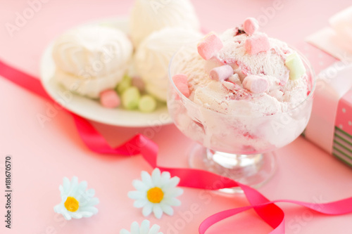 ice cream in a Cup next to the marshmallows, flowers, pink sweets