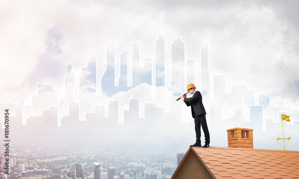 Engineer man standing on roof and looking in spyglass. Mixed media Engineer man standing on roof and looking in spyglass. Mixed media