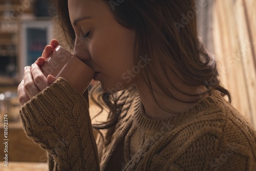 Woman drinking cup of coffee photo