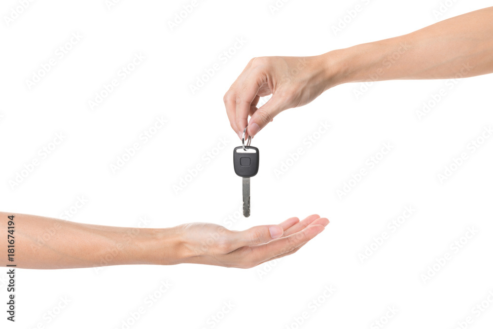 Hand holding car key and handing it over to another person isolated on white background Hand holding car key and handing it over to another person isolated on white background