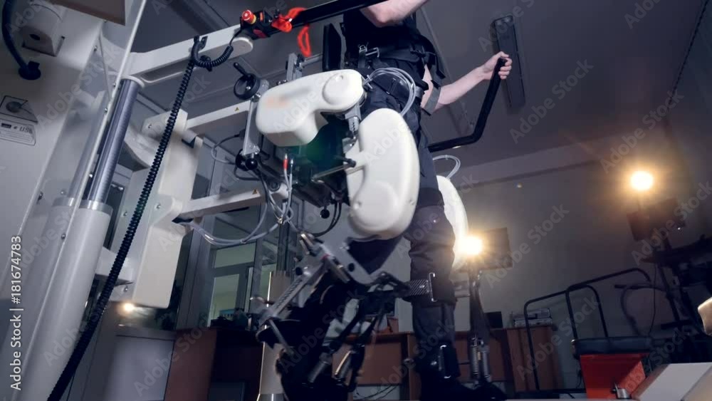 A low view on a man walking inside an exoskeleton. A low view on a man walking inside an exoskeleton.