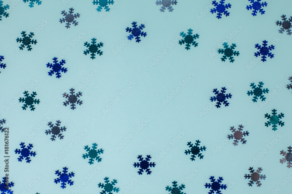 Winter pattern made of snowflakes on blue background. Winter concept. Flat lay. Minimal concept Winter pattern made of snowflakes on blue background. Winter concept. Flat lay. Minimal concept