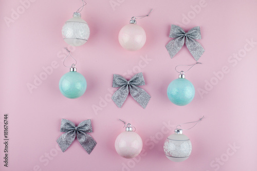 Pink and blue Christmas baubles with bows decoration on bright pink background. Flat lay. Holiday concept. Minimal idea