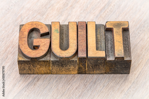 guilt word abstract in wood type photo