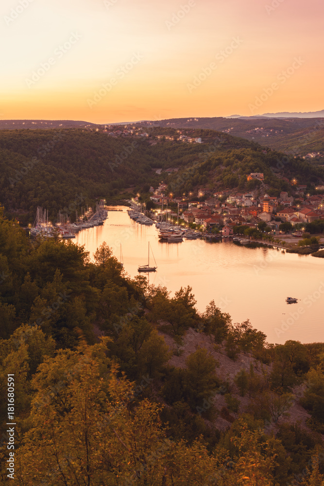 Small cozy town of Skradin on Krka river in sunset light, the entrance to the Krka National Park, vertical image, Dalmatia, Croatia