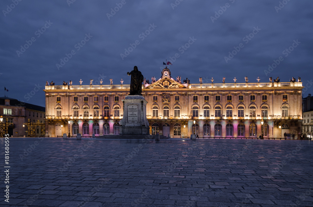 Square Stanislas in Nancy in the evening. In the center stands a monument to Stanislas. In the background there is a Town Hall building. Square Stanislas in Nancy in the evening. In the center stands a monument to Stanislas. In the background there is a Town Hall building.