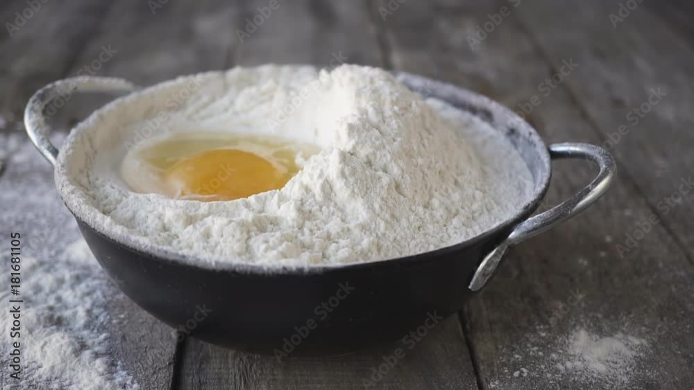 Slow motion of falling eggs into flour stock. Footage food concept Slow motion of falling eggs into flour stock. Footage food concept