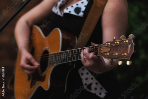 Closeup of a woman's hands playing guitar