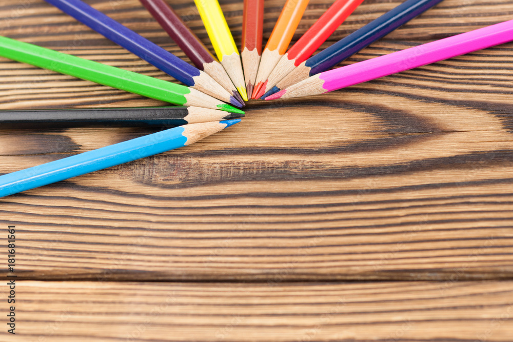 Lot of colored pencils on old brown wooden table Lot of colored pencils on old brown wooden table