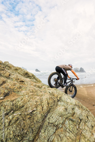 Man fat biking on rock on the Oregon coast