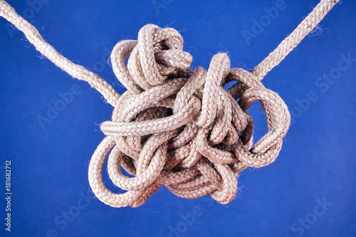 Cuadro en lienzo A tangled knot on a rope on a blue background.