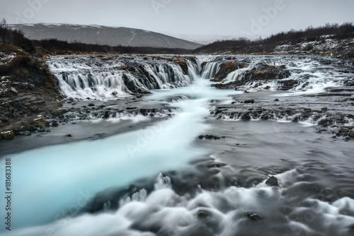 Aquarmine Waterfall in Iceland on Cloudy Day