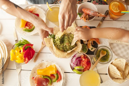 Mexican food hand of woman and child eating