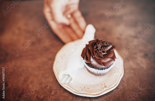 Waiter serving plate with delicious cake in a cafe, close up photo photo