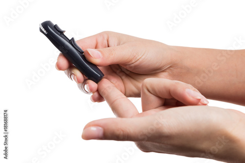 Woman hands poking finger to check glucose or blood sugar level