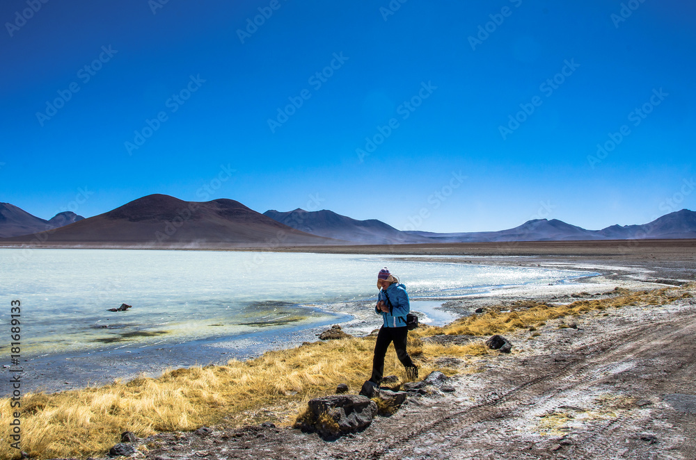 Girl runing on the Laguna Verde is a salt lake at the foot of the volcanos Licancabur and Juriques - Eduardo Avaroa Andean Fauna National Reserve, Bolivia