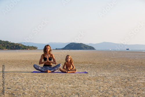 Mother with her son doing yoga