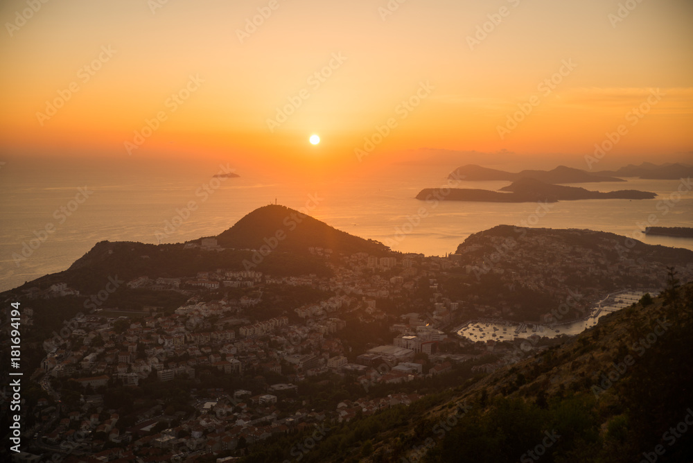 Sunset on the Adriatic sea with layers mountains on the horizon. Beautiful panoramic view of Dubrovnik, Croatia.
