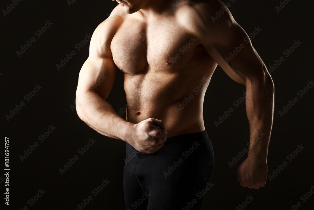 Powerful muscular man holding metal workout weight