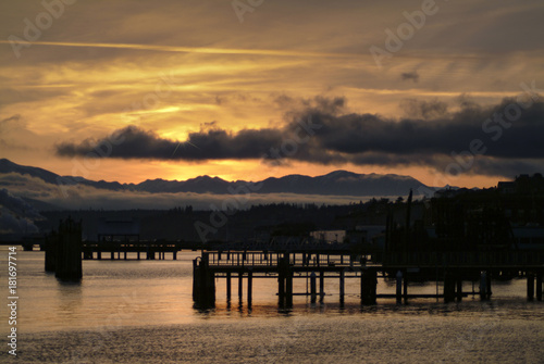 Port Townsend Waterfront at Sunset. The waterfront city of Port Townsend, Washington, has a long maritime history. The Olympic Mountains can be seen in the background. © LoweStock