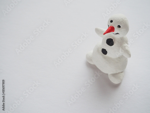Fun toy snowman on a light background 