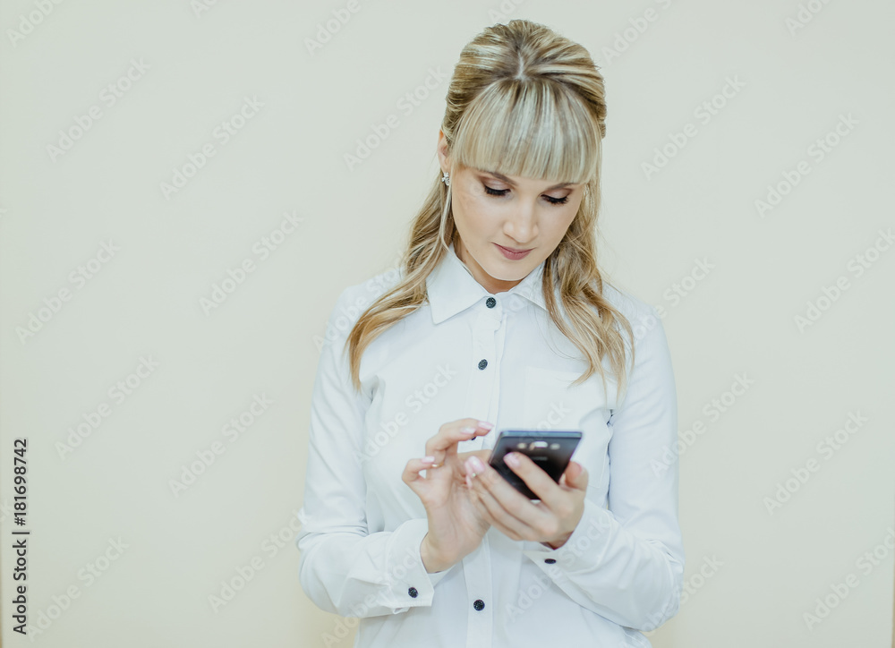 The girl beautician calls his client on a mobile phone. The girl beautician calls his client on a mobile phone.