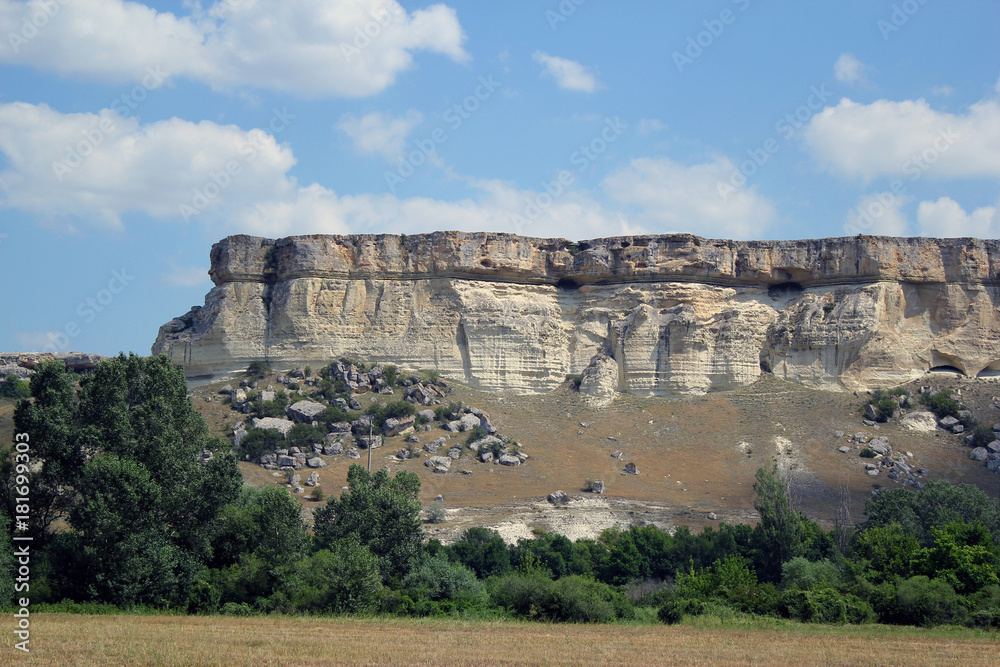 White rock or Aq Qaya on a Sunny summer day. Crimea. White limestone with a vertical cliff