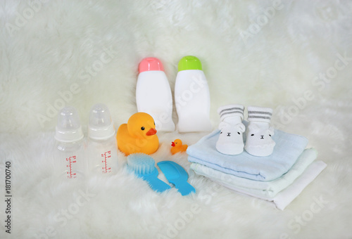 Children's bath products and hygiene items on white fur.